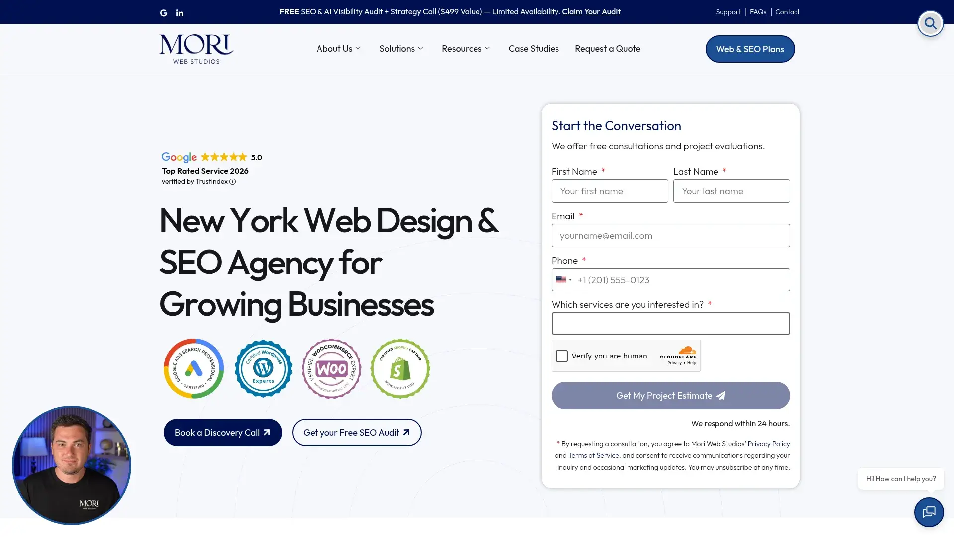 The Hidden Cost of Cutting Corners on Logo Design in New York's Market 2 Planning Your Next Step — New York small business owner reviewing logo mockups printed on paper at a wooden conference table, laptop open beside them, natural light from office window, brand color swatches pinned to a board on the wall